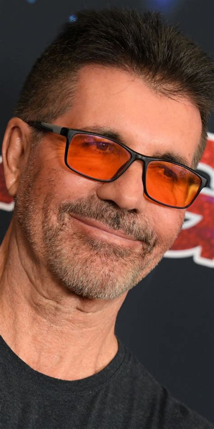 What's the Reason Behind Simon Cowell Wearing Red Tinted Glasses? Who Exactly is Simon Cowell? - SarkariResult